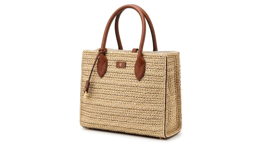 Luxury designer straw tote bag with leather handles on white background showing structured basket weave