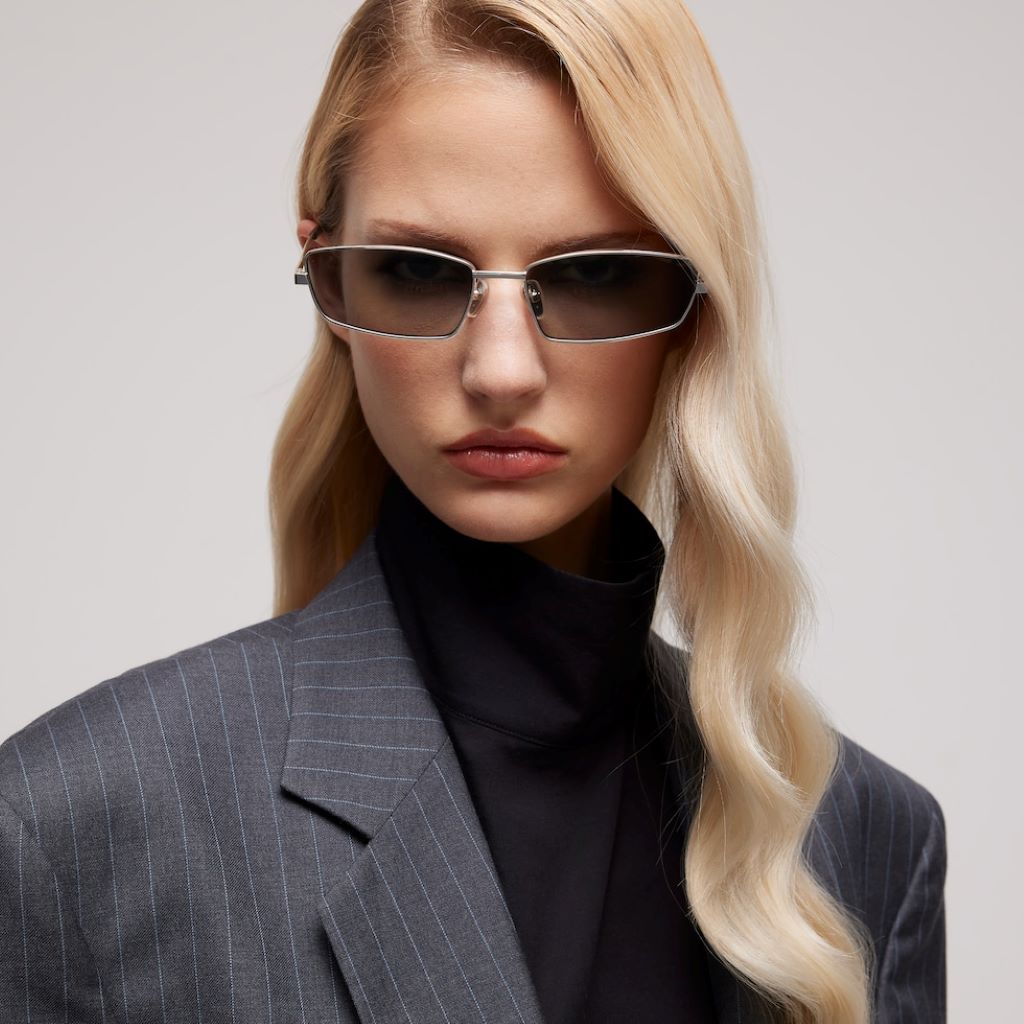 Fashion model pairing Gucci sunglasses with outfit for stylish summer look