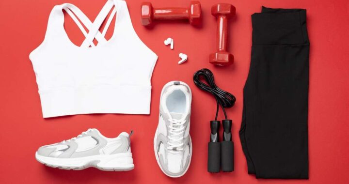 Woman sportwear outfit with equipment on color background, top view