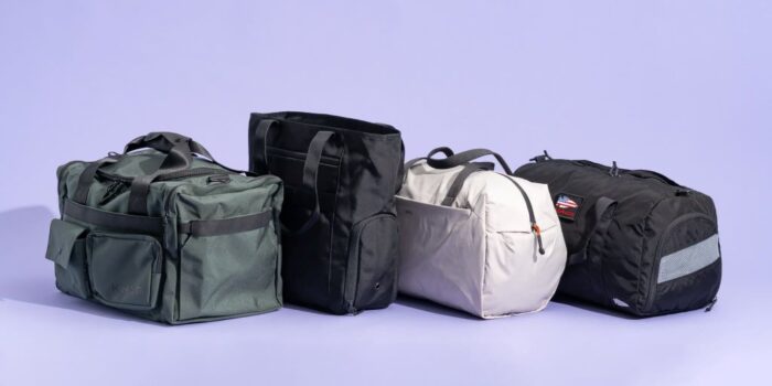 Stylish gym bag packed with workout clothes, shoes, and water bottle in a fitness gym