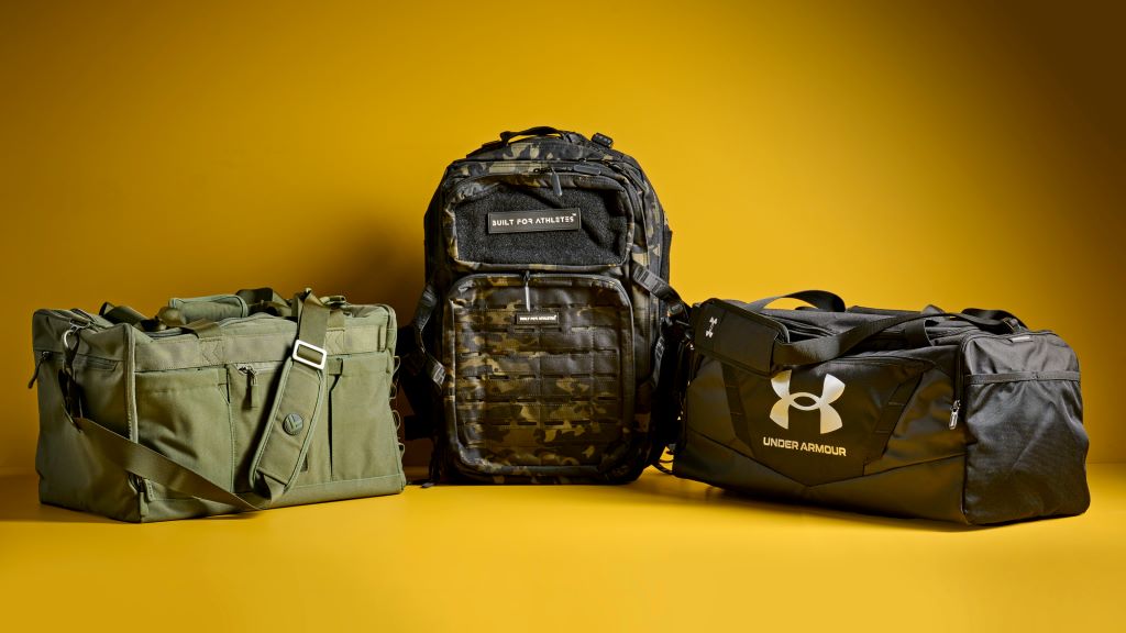 Athlete carrying a functional gym bag after workout in a modern fitness center