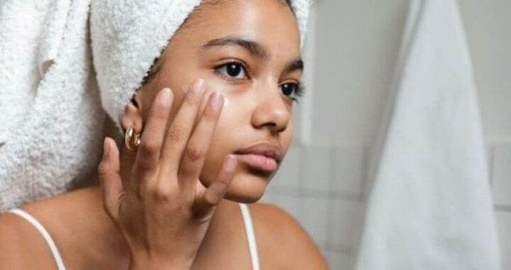 Woman applying Vitamin C serum to hydrate and brighten facial skin
