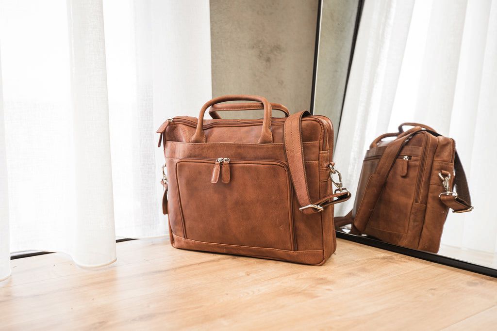 Close-up of a leather laptop bag featuring organized compartments and durable construction