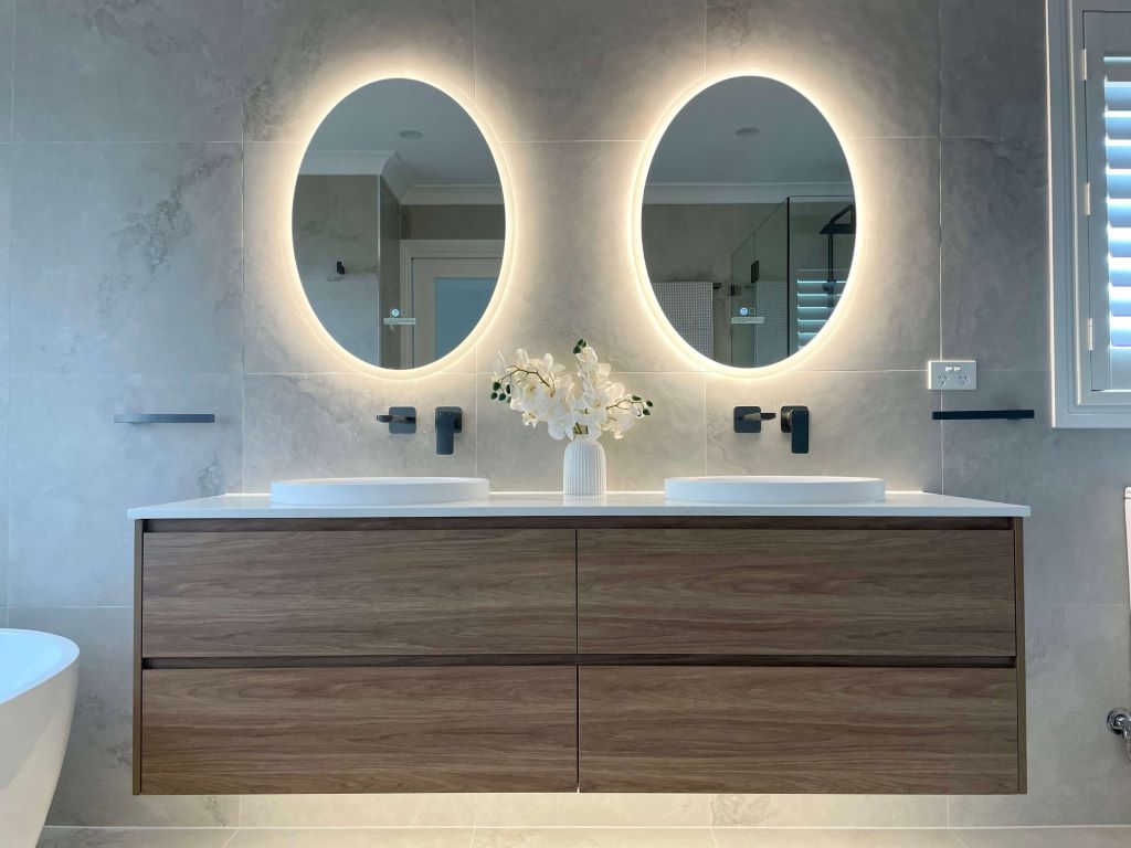 Luxury LED bathroom mirror illuminating a modern vanity with elegant lighting
