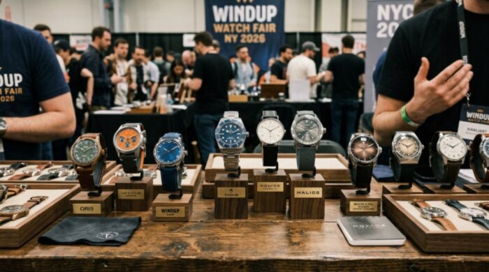 A close-up of multiple luxury and independent wristwatches displayed on a booth table at the Windup Watch Fair New York 2026